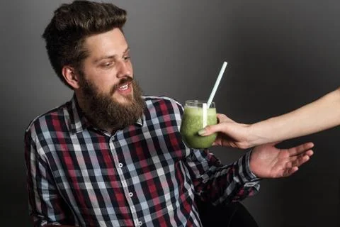 Man with spinach smoothie Stock Photos