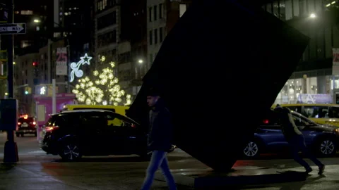 Man spinging the cube sculpure in NYC Astor Place before the cube was removed. Stock Footage 257476113