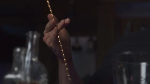 Man spining mixing spoon in bar in slow motion Stock Footage 90123470