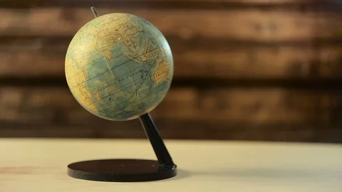 Man spinning a globe and pointing on it Видео 89028030