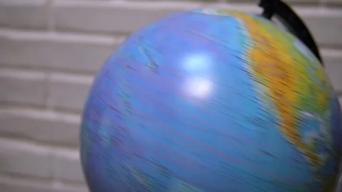 Man spinning a globe and pointing on it. Man choosing his next travel on a Stock Footage 120305422