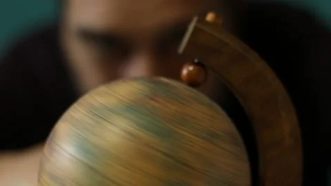 Man spinning a globe, close-up Stock Footage 162571711