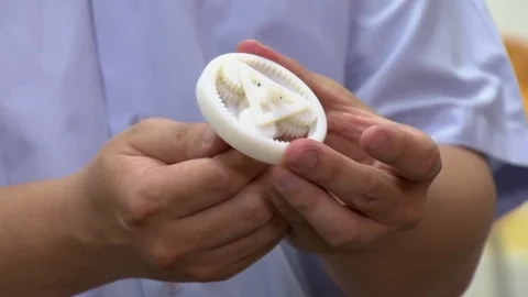 A man is spinning with his hands a planetary gear printed with 3D technology. Stock Footage 81852735