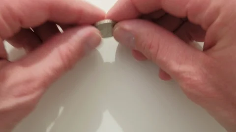 A man spinning a US quarter dollar coin Video stock 87148024