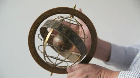 Man spins armillary sphere Stock Footage 24693313