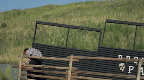 Man spins screws on the fence Stock Footage 59371509