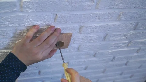 The man spins the socket with a screwdriver and removes it the Stock Footage 120291931