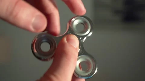 A man spins a spinner in his hand, playing with a spinner Stock Footage 175751921