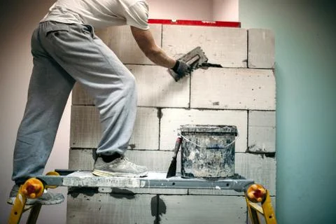 Man spits a wall of blocks Stock Photos