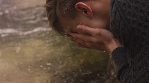 Man Splashes Face with Water Stock Footage 77984247