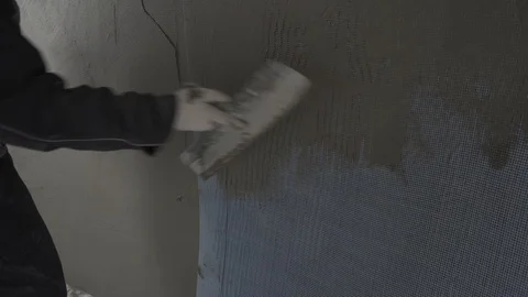 A man splashes a wall with a spatula Stock Footage 101660912