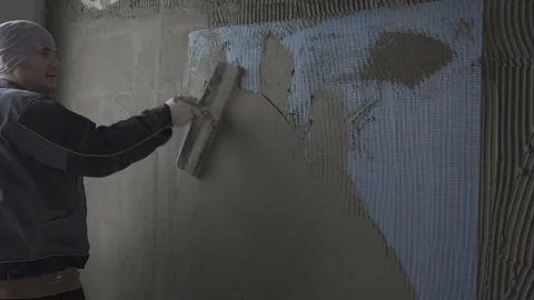 A man splashes a wall with a spatula Stock Footage 101661926
