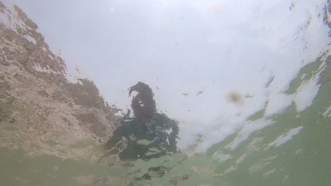 Man splashing water surface. Underwater shot. Stock Footage 108720344