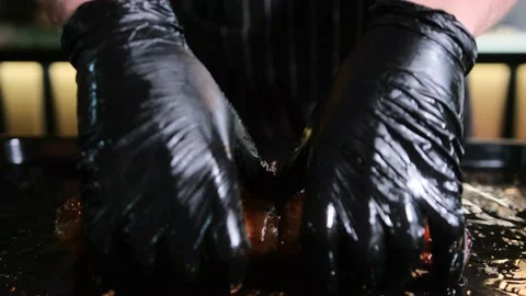 Man split smoky crunch pig rib with hands in black gloves. Stock Footage 167706554