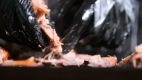 Man split smoky crunch pork rib with hands in black gloves. Stock Footage 167706651