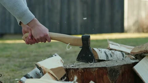 Man Splitting A Log With An Axe. Chopping Wood Stock Footage 238525337