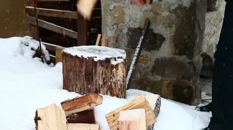Man splitting wood wintertime Stock Footage 10761095