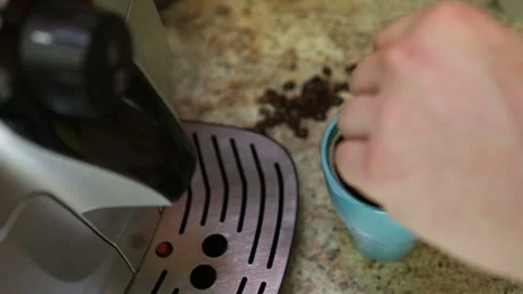 Man is spoiling with a spoonful of freshly brewed morning coffee in a blue glass Stock Footage 112686540