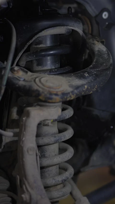 Man spraying black protective anti-corrosion coating onto car chassis part. Stock Footage 344363340