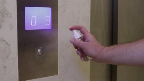 Man is spraying disinfectant on elevator's button Stock Footage 140532982