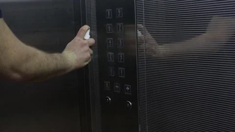 Man is spraying disinfectant on elevator's button before pressing the button Video stock 140978479