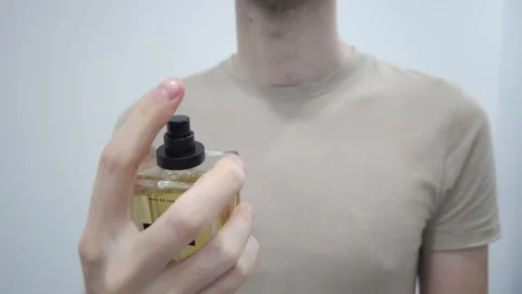 Man spraying perfume from bottle. Personal care and fragrance concept. Stock-Footage 283931607