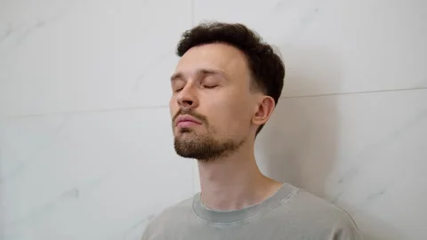 Man spraying perfume on neck in bathroom Stock-Footage 311976100