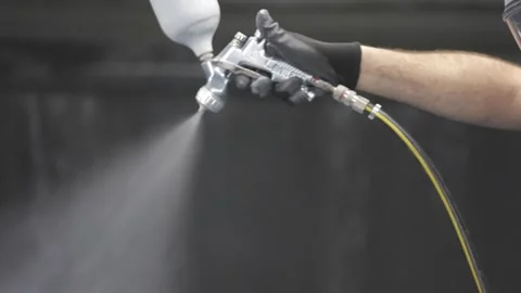A man is spraying water with a hose Stock Footage 302456643