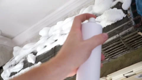 Man sprays special foam to clean air conditioners on the radiator. Split system Stock Footage 197496481