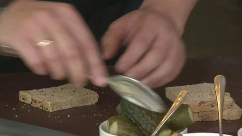 Man spreading butter on a bread slice Stock Footage 80361357