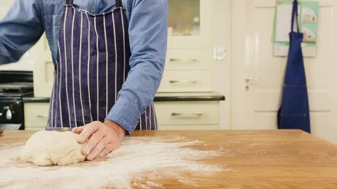 Man Spreading Flour While Kneading Dough On Table At Home Stock Footage 86074528