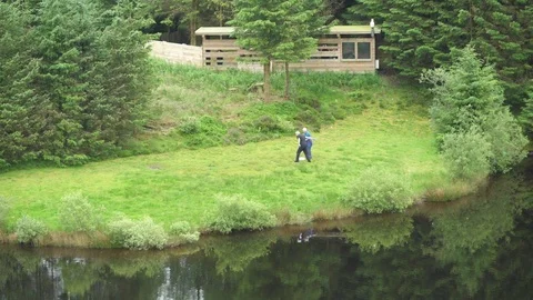Man spreading meat scraps for red kites at feeding station Video stock 82653141