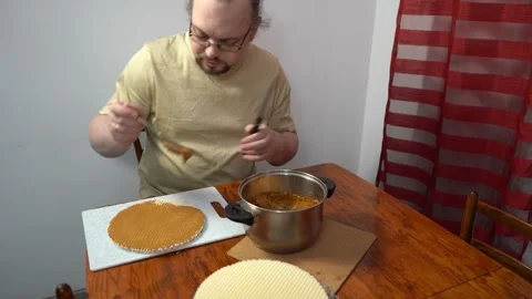 Man spreading wafer cakes with condensed milk. Simple cake. Sweet food. Hands Stock Footage 331992837