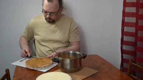 Man spreading waffle cakes with condensed milk. Make cake cream. Sweet food Stock Footage 346890338