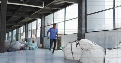 Man sprinting from far corridor in industrial fitness drill, jumping over large Stock Footage 333903171