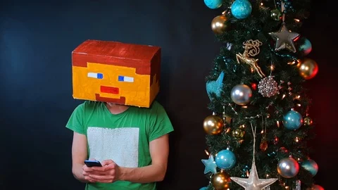 A man in a square mask on his head uses a smartphone. Stock Footage 121253524