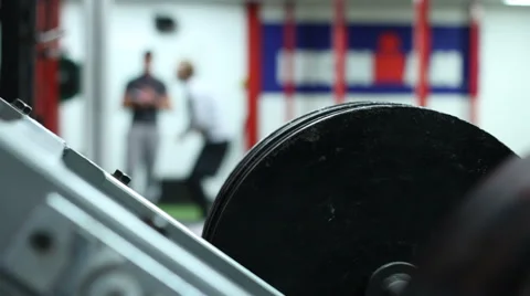 Man Squatting in Background - Out of Focus Vídeo Stock 60762652