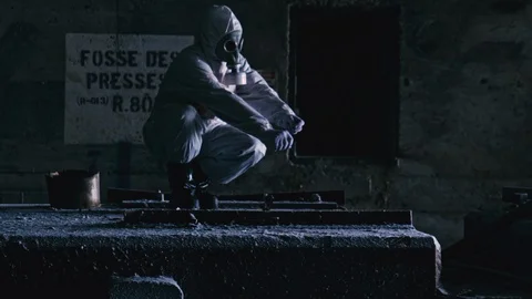 Man Squatting While Lighting The Color Smoke Bomb Inside The Old Stock Footage 128915843