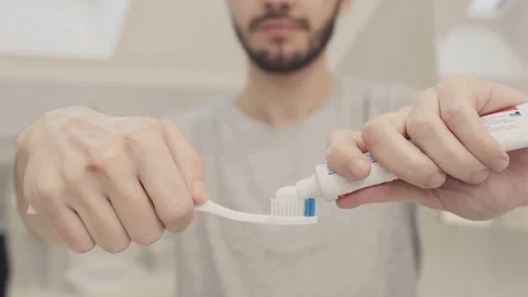 Man squeeze toothpaste on toothbrush Stock Footage 83179736