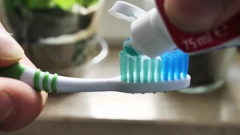 The man squeezes the paste on the brush Video stock 149273079