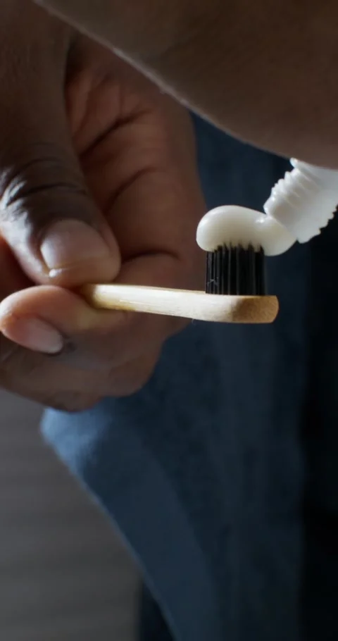 A man squeezes toothpaste onto a brush Stock Footage 313085384