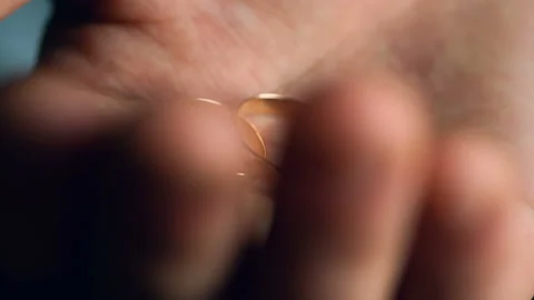 A man squeezes two wedding rings in his hand. Closeup Stock-Footage 105432970