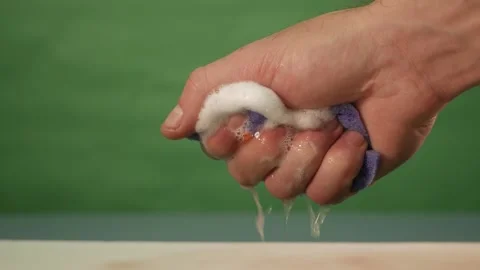 The man squeezes a wet sponge Stock Footage 163717045