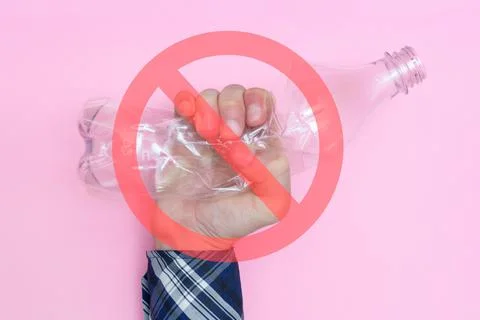 Man squeezing an empty plastic bottle. Prohibition sign. Against the use of Stock Photos