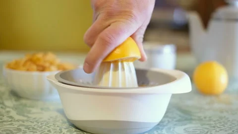 Man squeezing fresh orange fruit on juicer,healthy eating breakfast,morning diet Stock Footage 146016390