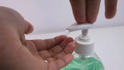 Man squeezing hand sanitizer from bottle for virus and bacteria prevention Stock Footage 127515620