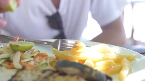 Man squeezing lemon on meat Stock Footage 85775120