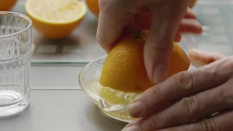 Man squeezing an orange to make orange juice Stock Footage 85433748