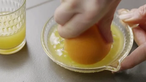 Man squeezing an orange to make orange juice Stock Footage 85433751