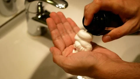 A man squeezing shaving cream on hand Stock Footage 91395247